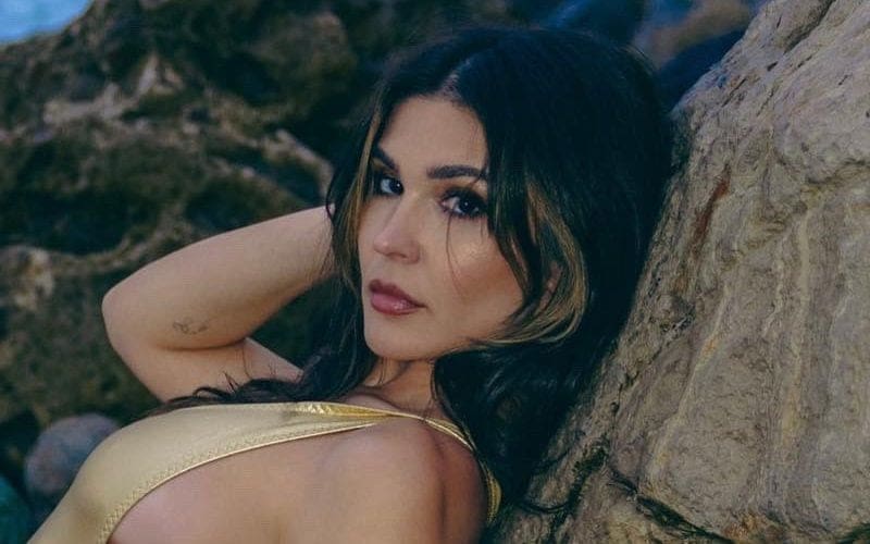 Cathy Kelley Scales Rocks In Skimpy Gold Swimsuit